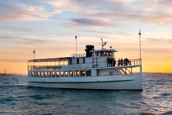 CHL_Contact-Boston a classic harbor line motor yacht cruising across the water with passengers on board